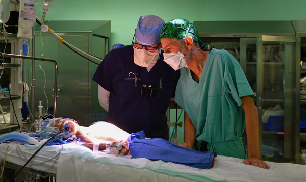 Dr. David Adams and Dr. Juan Leon of CEDIMAT discuss their surgical plan for one-year-old Yailin.