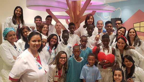 Eight patients who received mitral valve repair surgery during the May 2019 Mitral Foundation medical mission pose with staff at CEDIMAT after their operations