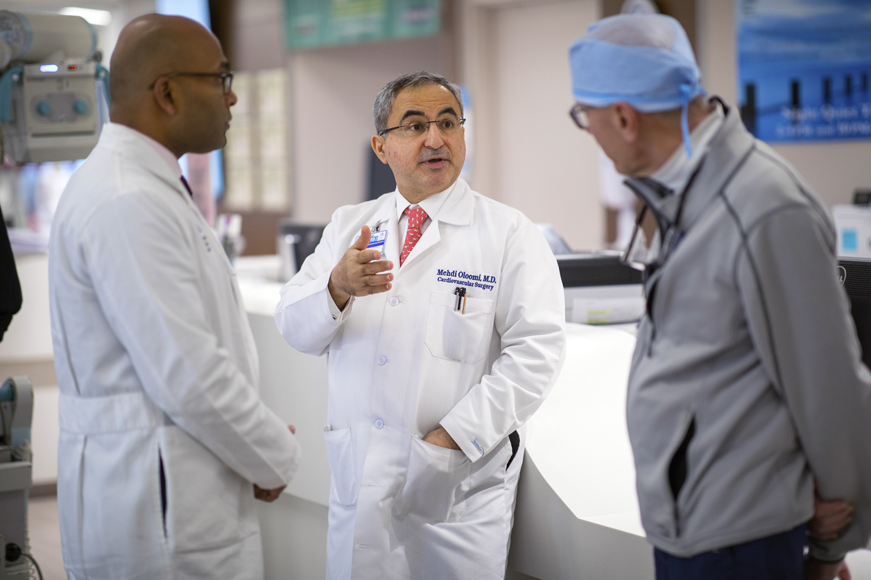 Dr. Oloomi consults with Drs. Adams and Varghese in the ICU at The Mount Sinai Hospital