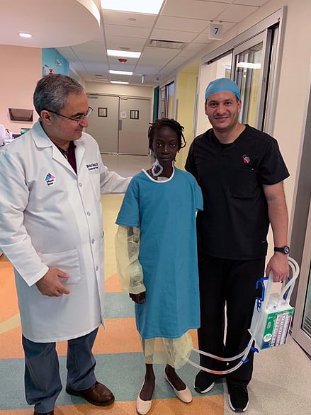 Dr. Oloomi supervises Naika's (16) recovery after mitral valve repair during a medical mission to the Dominican Republic.