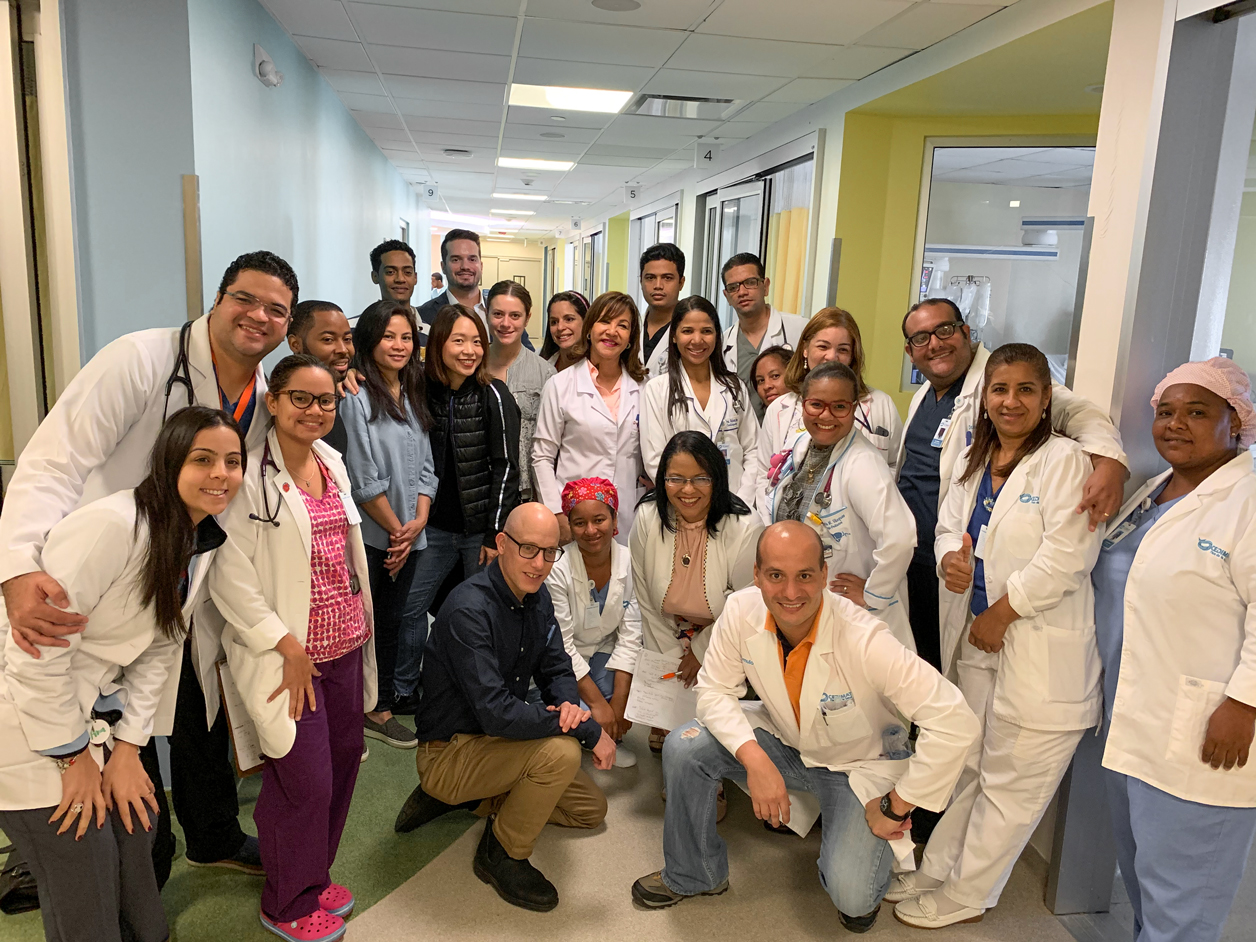 Dr. Toribio (center) and the team gather to celebrate a successful round of surgeries that saved seven children.