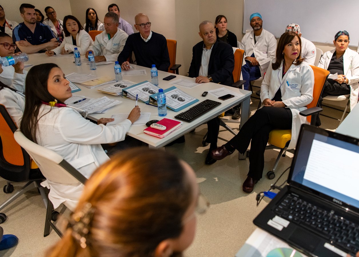 Dr. Toribio (front right) leads a case review before the team heads into the Operating Room for surgery.